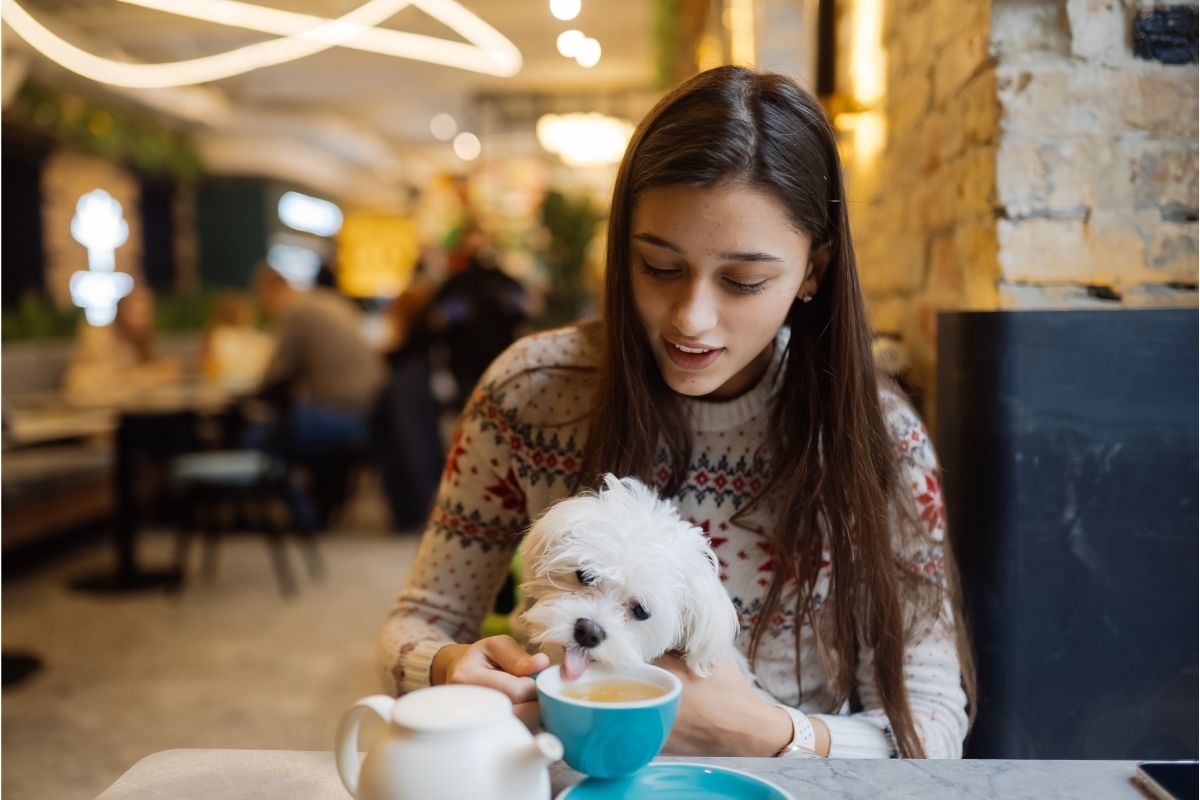 Woman Is Holding Dog Drinking Coffee